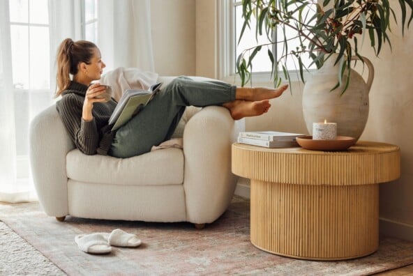 Camille Styles wearing loungewear sitting in armchair_stress and gut health