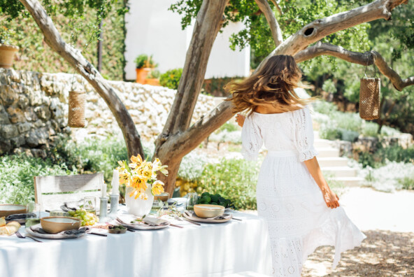 summer table setting ideas, Camille Styles summer dinner party table in backyard with trees, dancing, dance, twirling