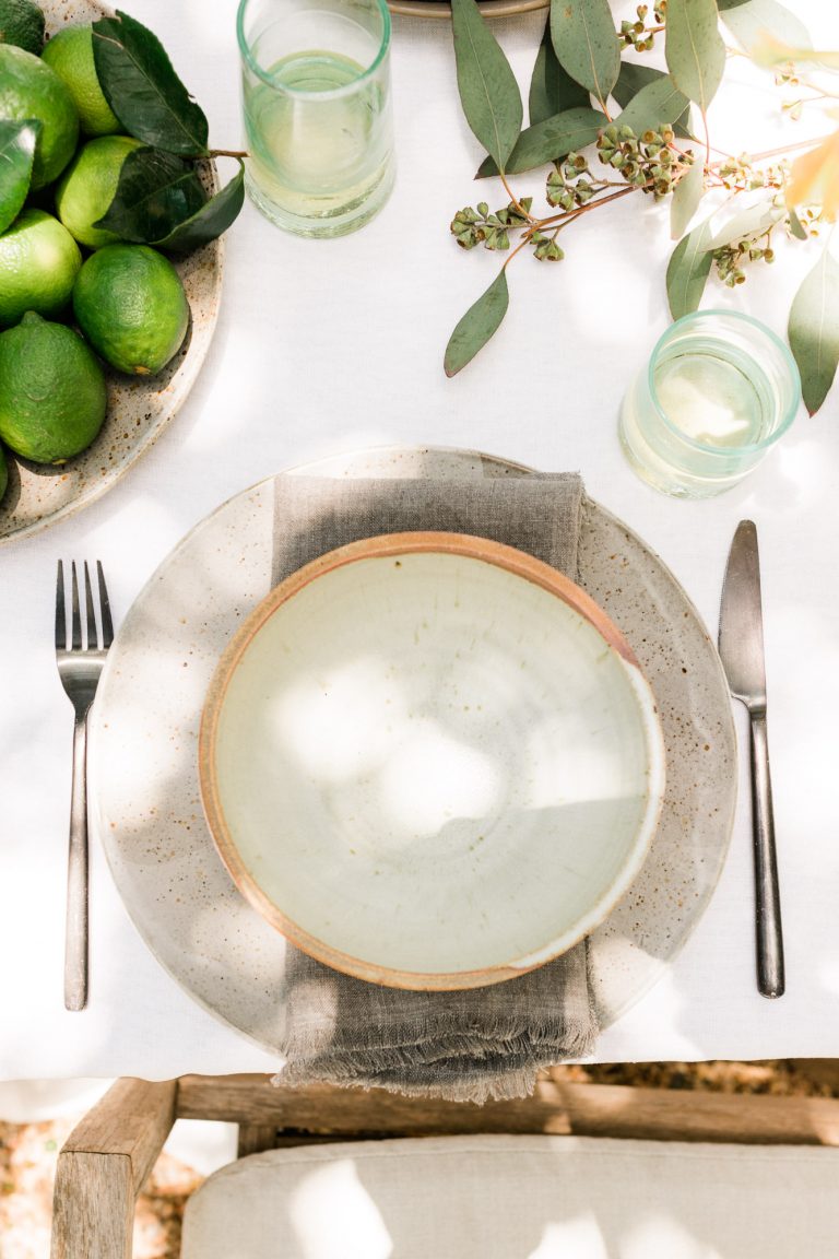 rustic place setting for a backyard dinner party with ceramic plates