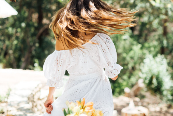 dance, celebrate, twirl-summer table setting ideas, Camille Styles summer dinner party table in backyard with trees, white dress_ovulatory phase