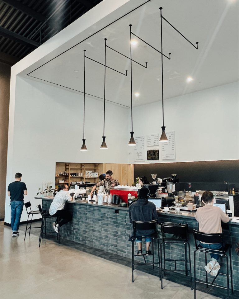 People working at the bar at Caffé Medici Springdale location in Austin.