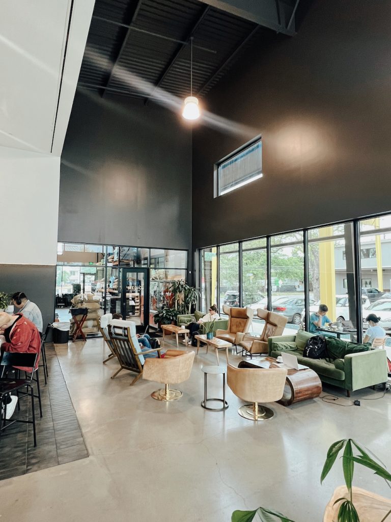 People working in the seating area at Caffé Medici Springdale location in Austin.