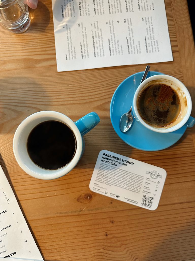 Two black coffee in blue cups and saucers at Proud Mary in Austin.