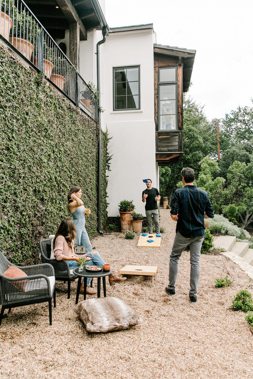 yard games, bean bag throwing, friends hanging out - backyard game night with goal