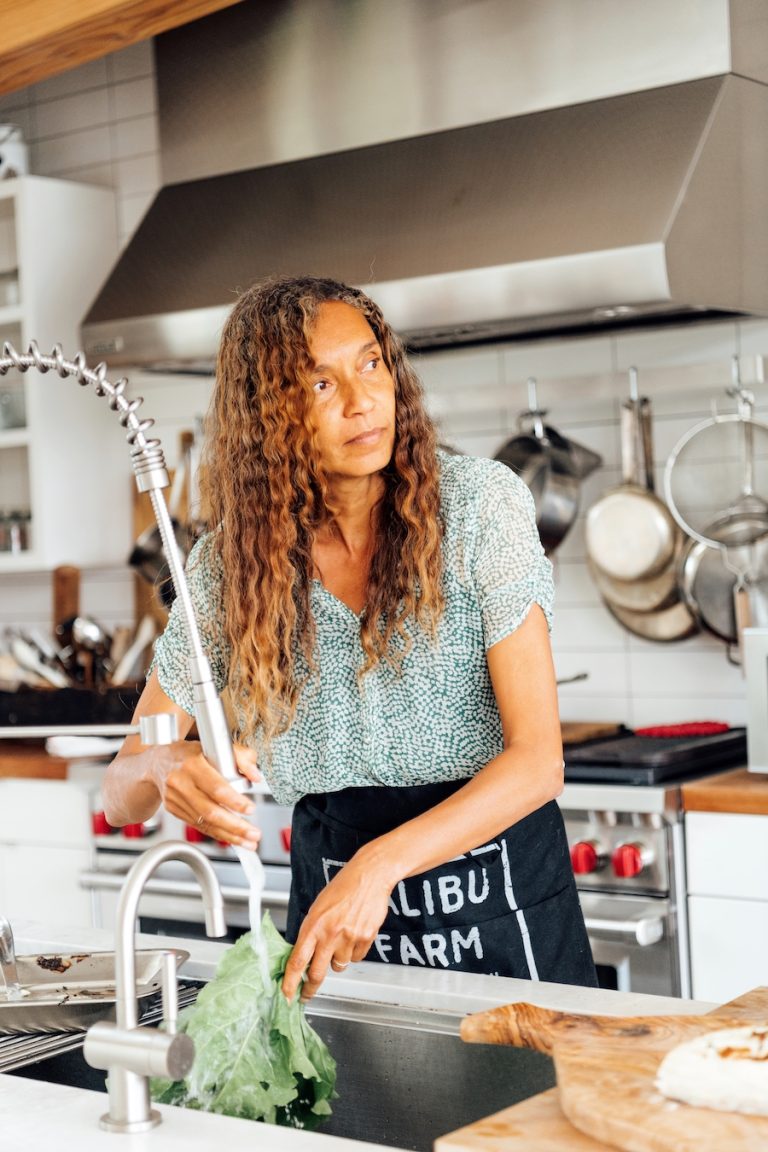 Helene Henderson of Malibu Farm at her home, washing veggies in the kitchen