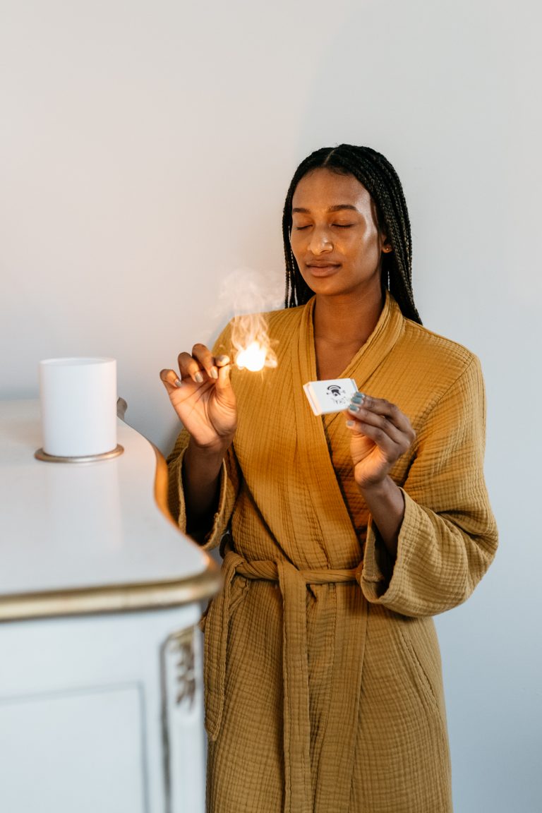 Woman lighting candle.