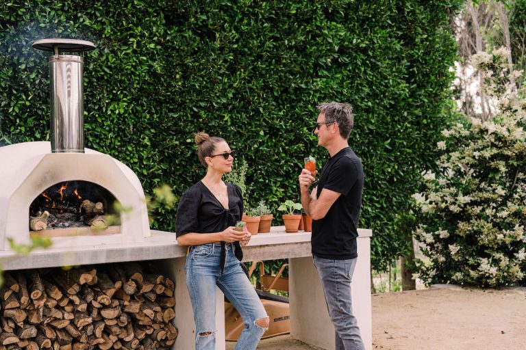 beautiful backyard at sunset with covered terrace and pizza oven - helene henderson home - malibu farm - couple - camille and adam - date - romance