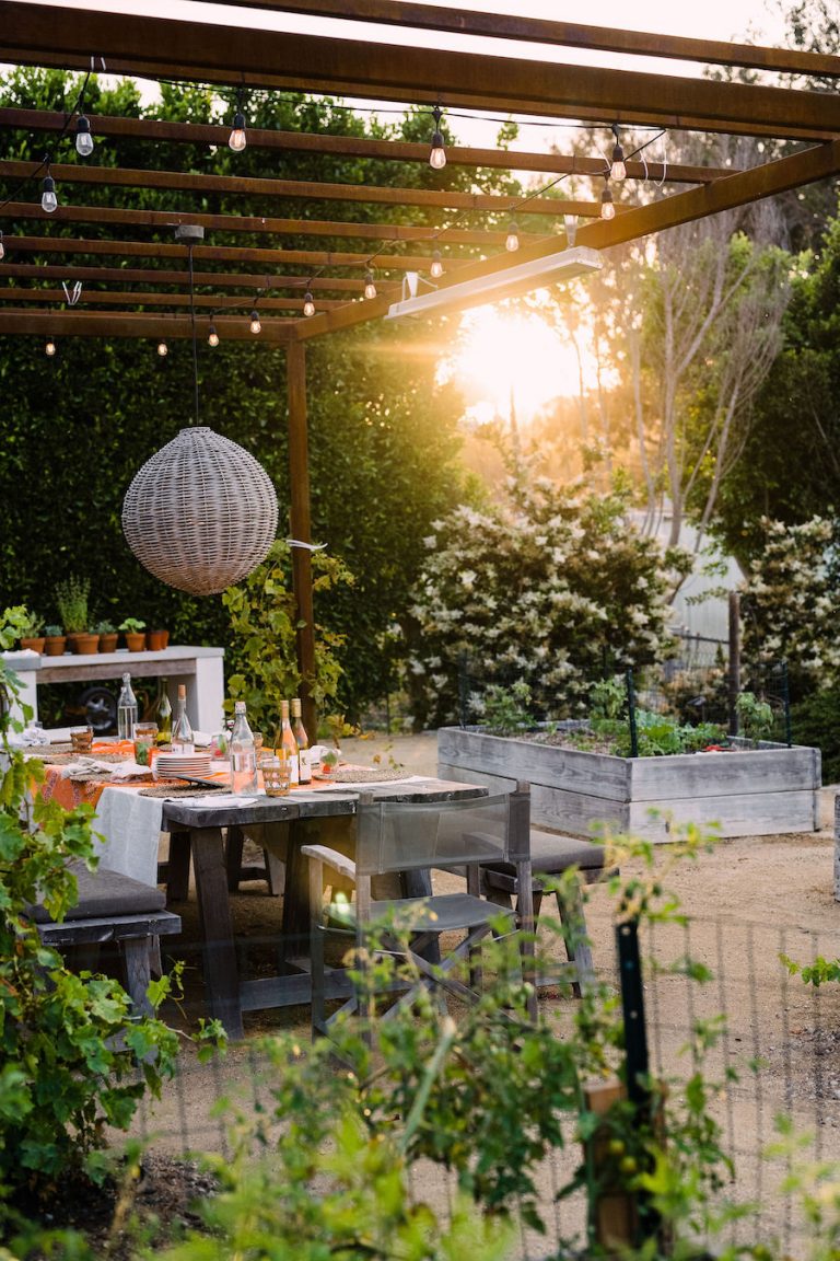 beautiful backyard at sunset with covered terrace and pizza oven - helene henderson home - malibu farm