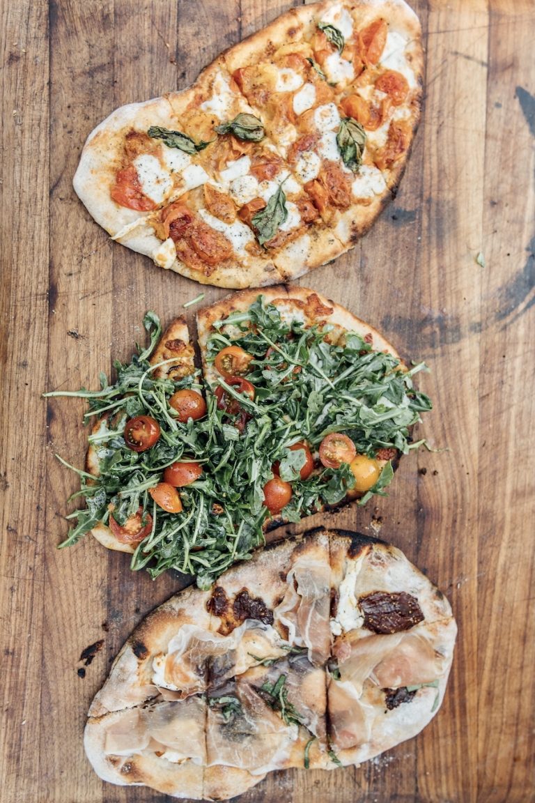 charred pizzas from the pizza oven at plumcot farm