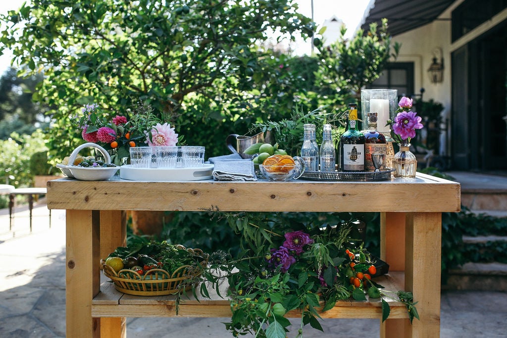 Valerie Rice dinner party in Santa Barbara, bougainvillea and mediterranean house exterior, bar on potting bench setup