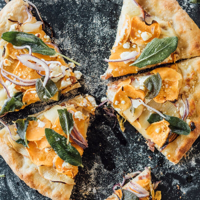 homemade fall pizza with sweet potatoes, apple, bacon and fried sage