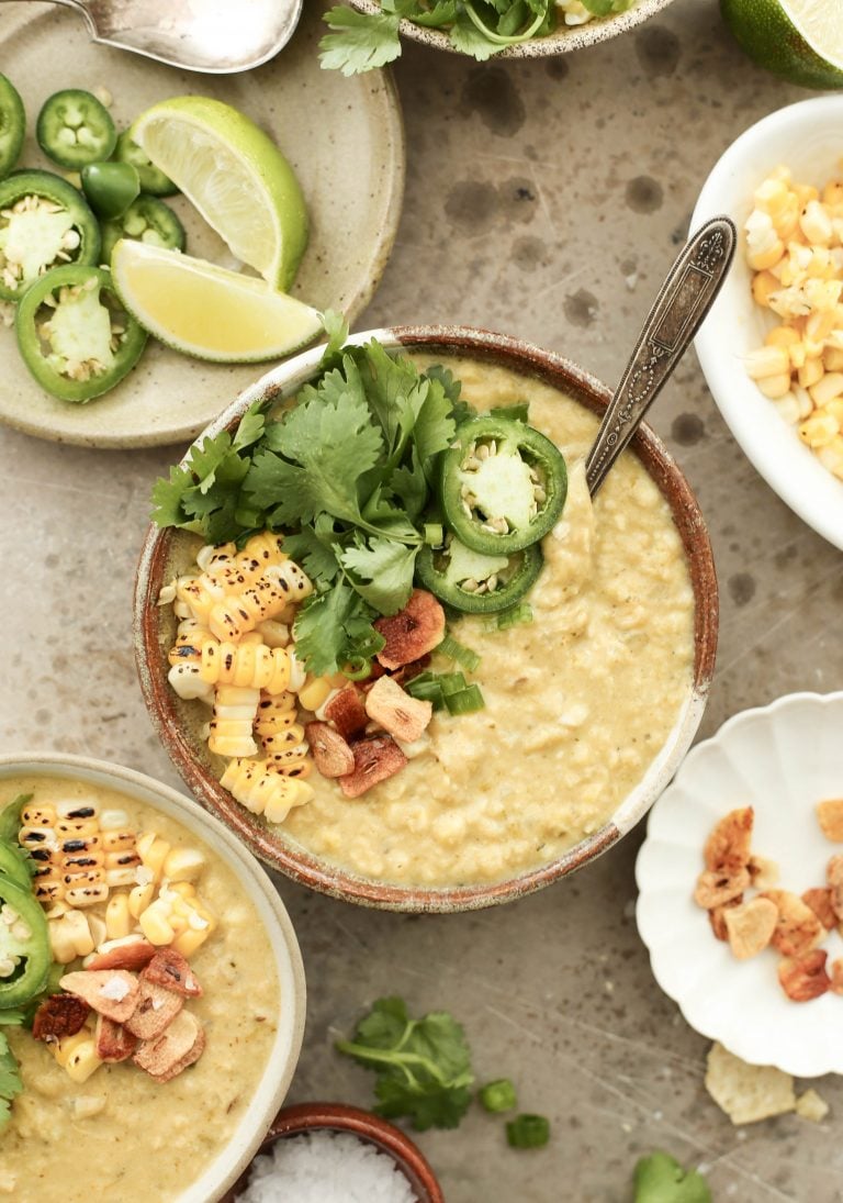 a pot of spicy and vegan corn soup with poblano peppers and coconut milk