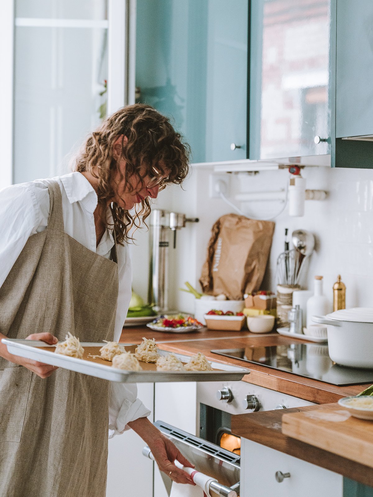 Rebekah Peppler putting coconut macaroons into the oven at her Parisian dinner party