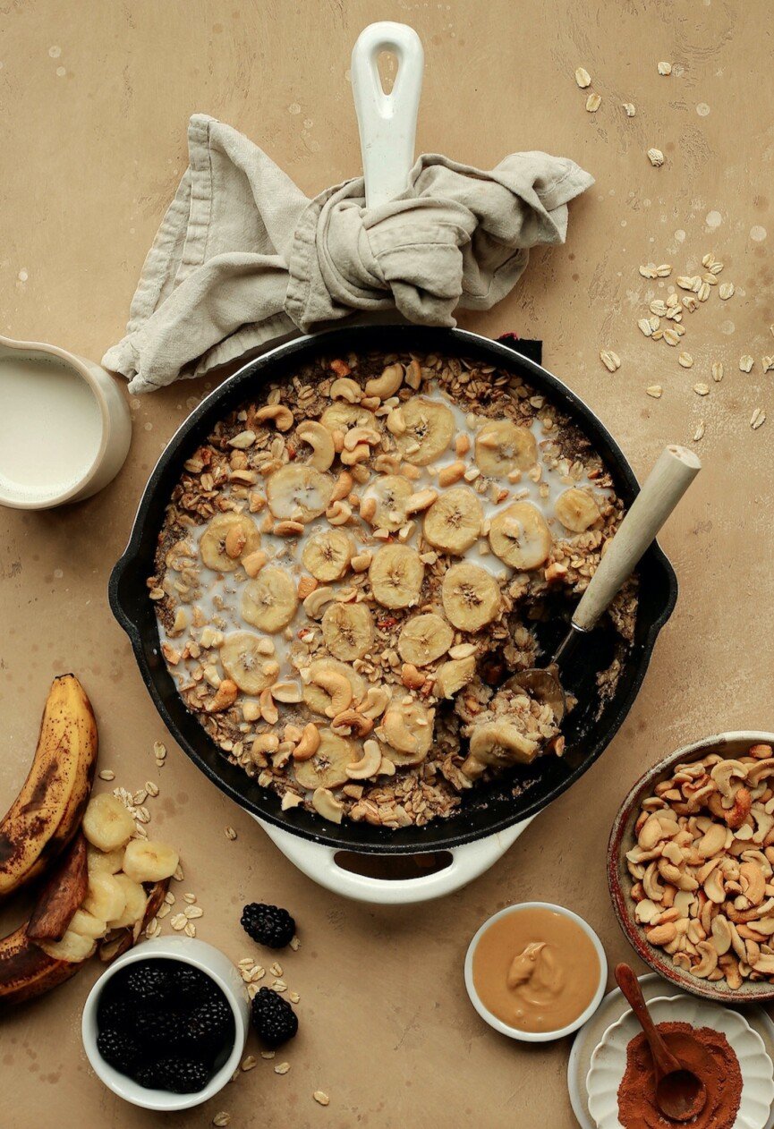 Warm banana baked oatmeal topped with cashews and honey — a cozy, mood-boosting breakfast