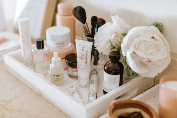 Beauty products on white tray.