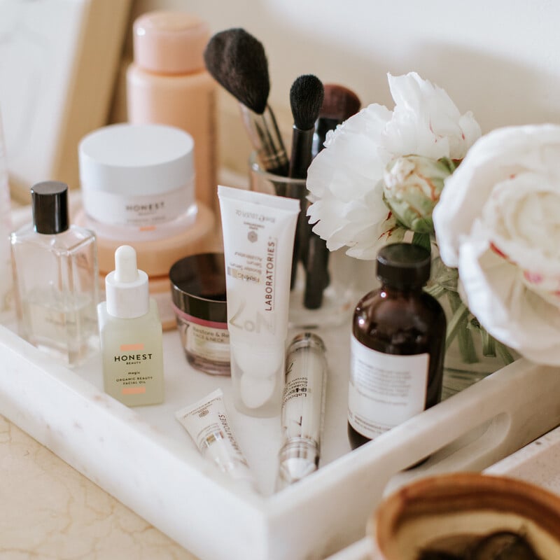 Beauty products on white tray.