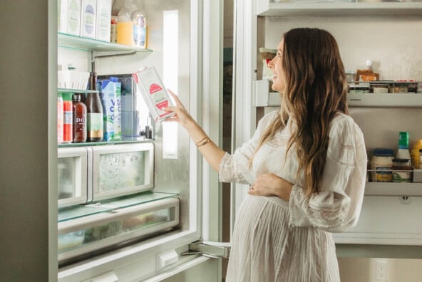 Woman reaching into fridge