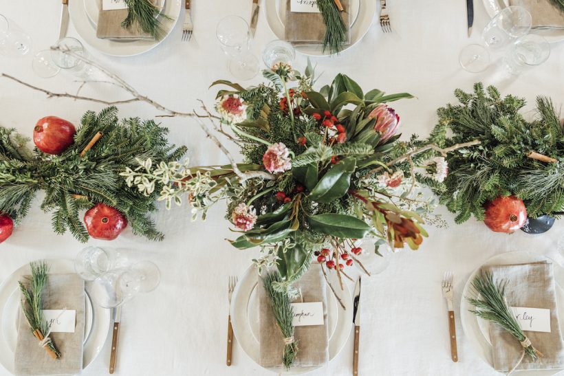 Holiday tabletop with evergreen and pomegranates