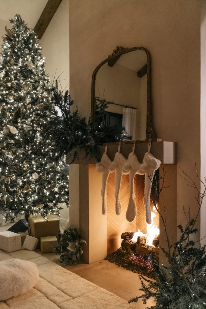 modern cozy christmas by the fire, holiday twinkling lights, camille styles living room