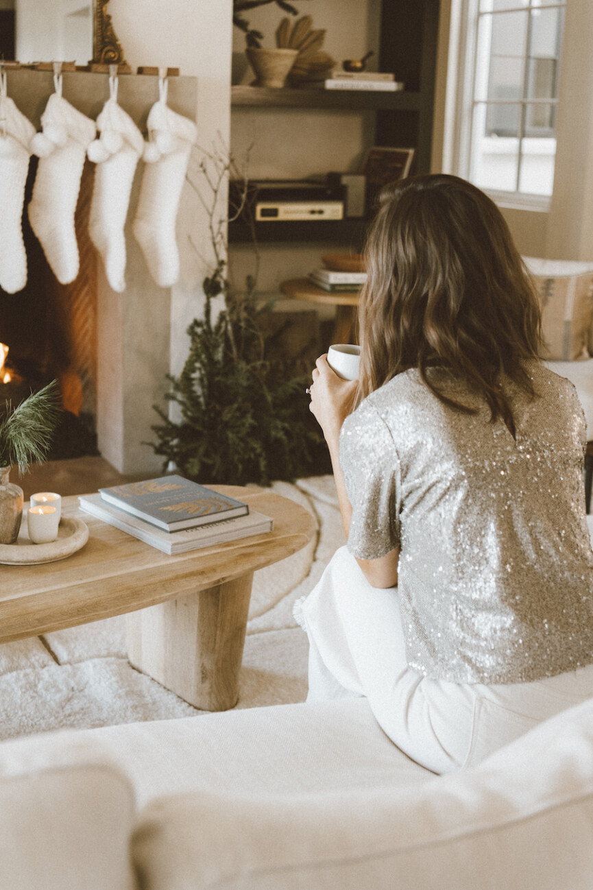 neutral stockings and evergreen christmas garland ideas, camille styles living room