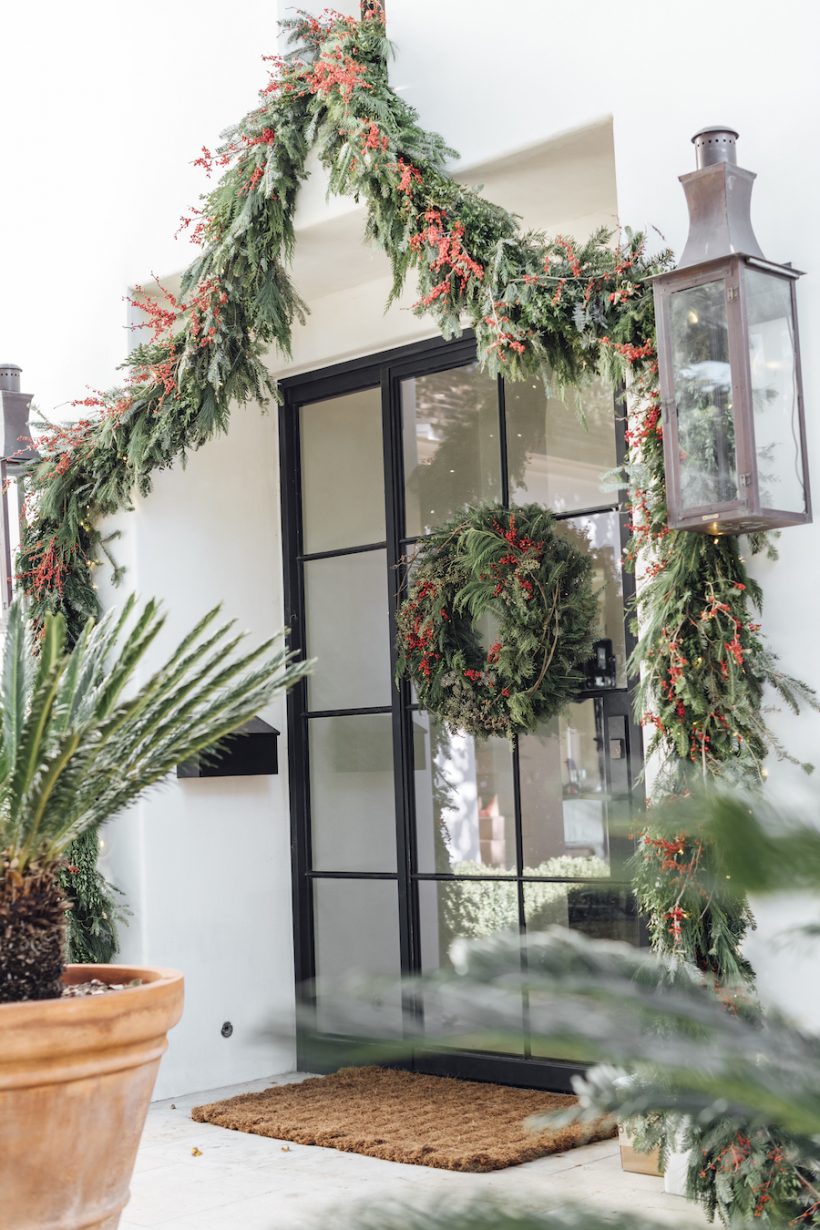 christmas evergreen garland and wreath with red berries for front door, best holiday decor front porch, how to make a christmas wreath and garland