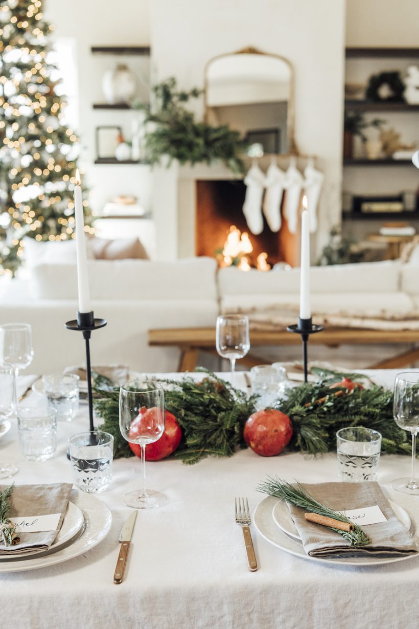 simple christmas table setting ideas-scandinavian inspired holiday tabletop with evergreen and pomegranates