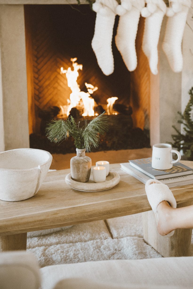 neutral stockings and evergreen christmas garland ideas, cozy by the fire, camille styles living room