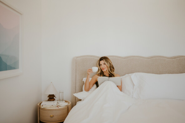Woman drinking tea in bed_colostrum and gut health