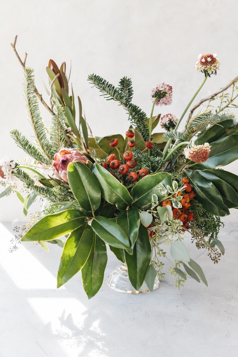 simple christmas table setting ideas-scandinavian inspired holiday tabletop with evergreen and pomegranates-camille setting table