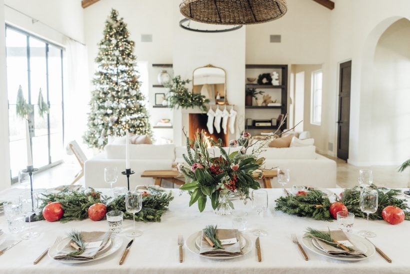Christmas table ideas — holiday table with evergreen leaves and pomegranate