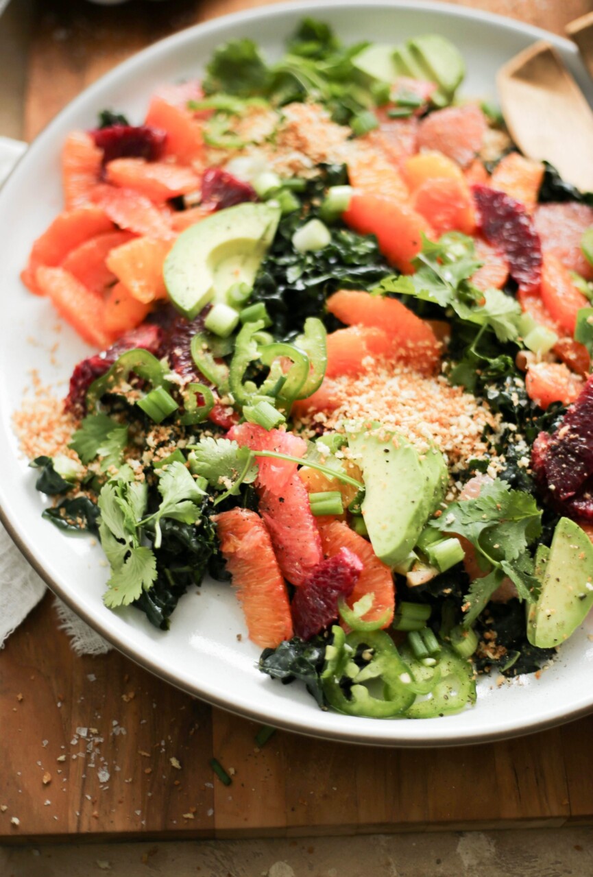 this kale and citrus salad with spicy tahini dressing is sunshine on a plate