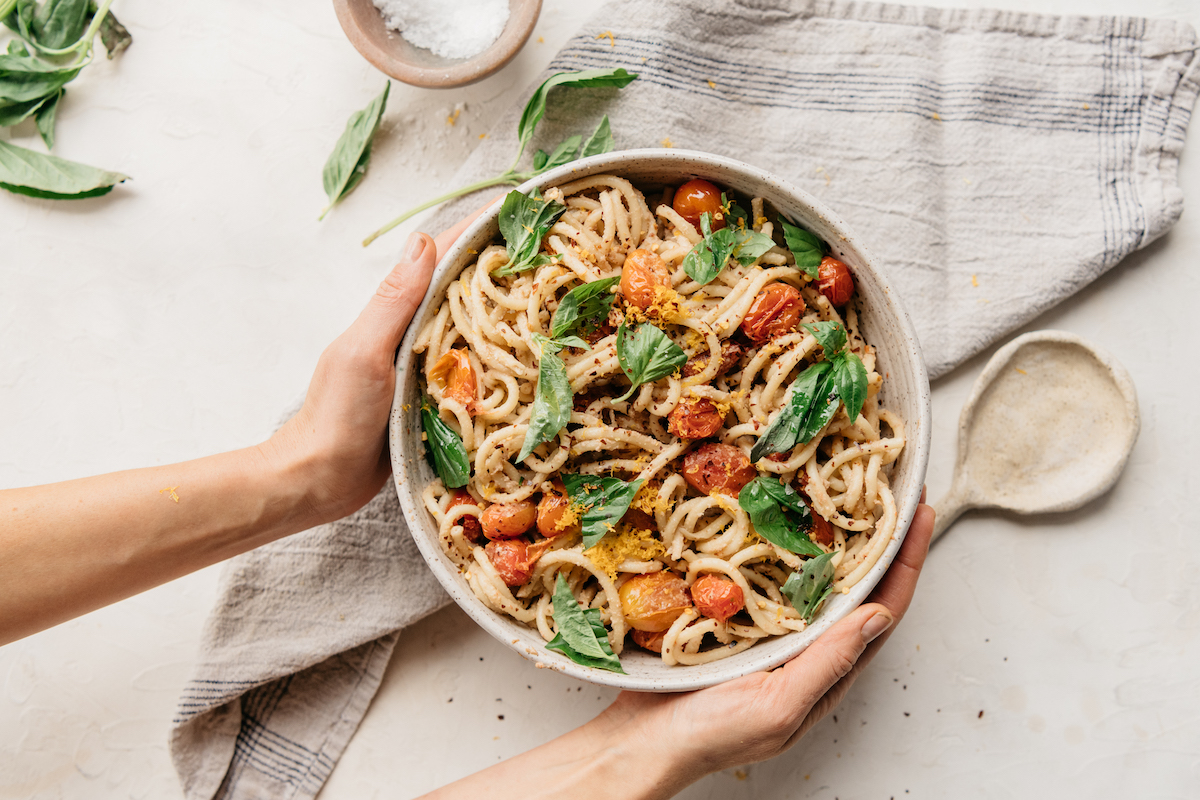 creamy vegan bucatini pasta with roasted tomatoes and basil