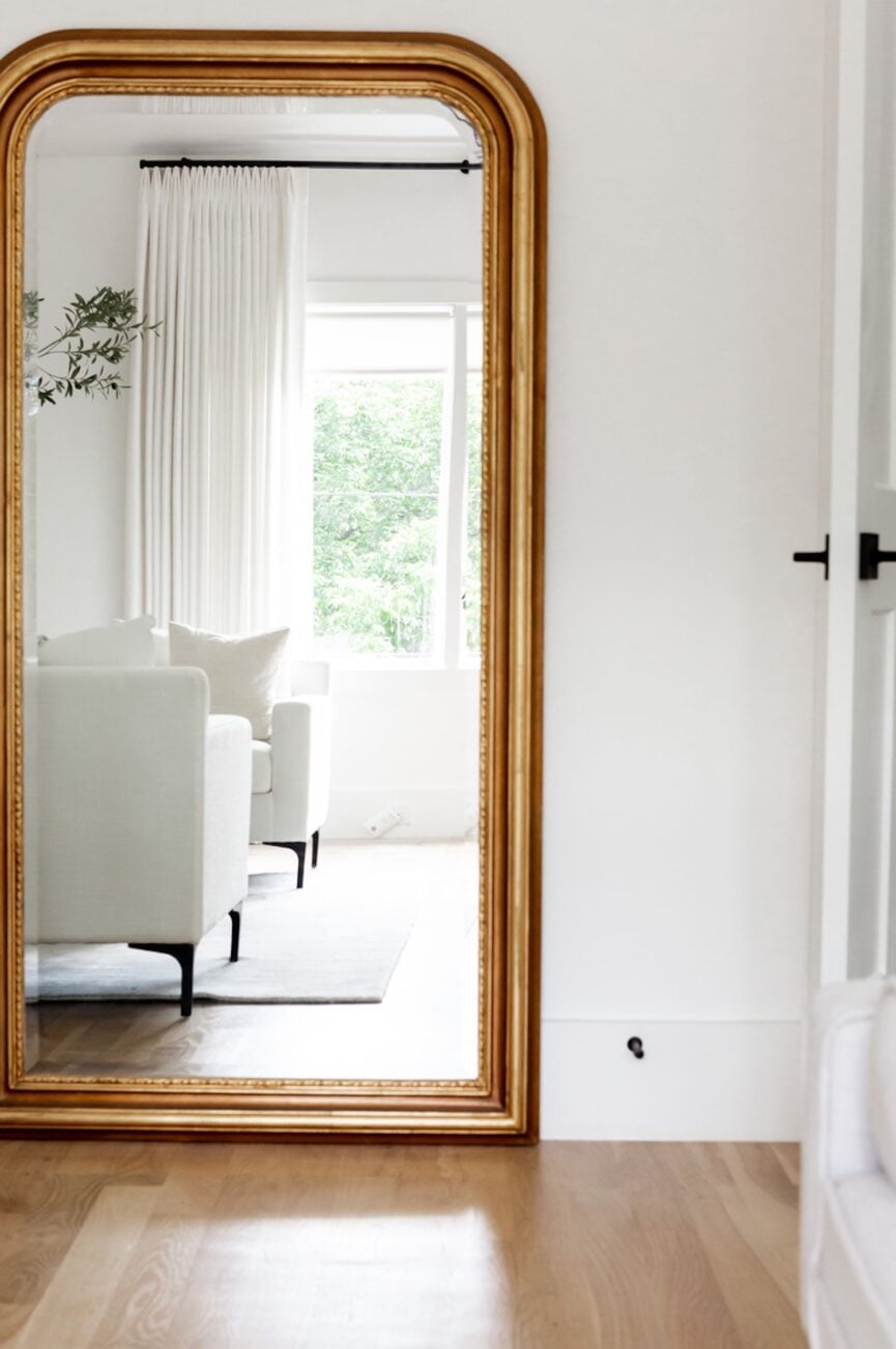 Mirror in a bright and white living room.