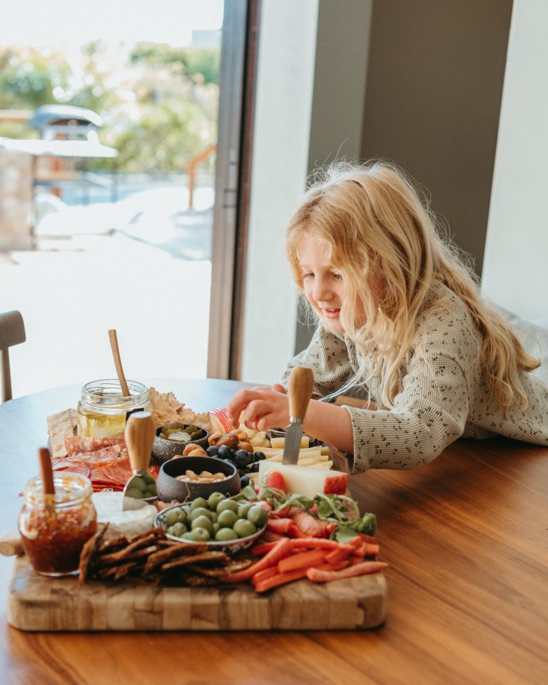 young girl eating cheese board_how to get fussy eaters to eat vegetables