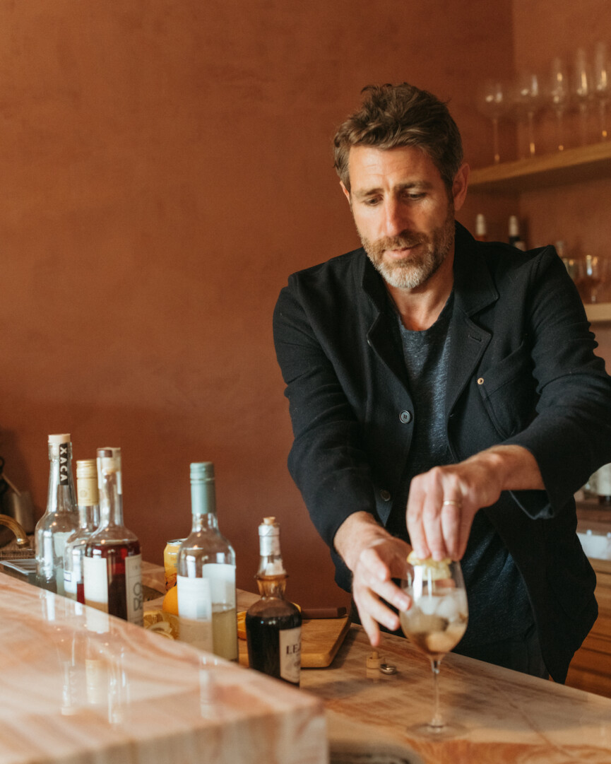 brian de lowe making cocktails at bar, colorful wall paint, white negroni