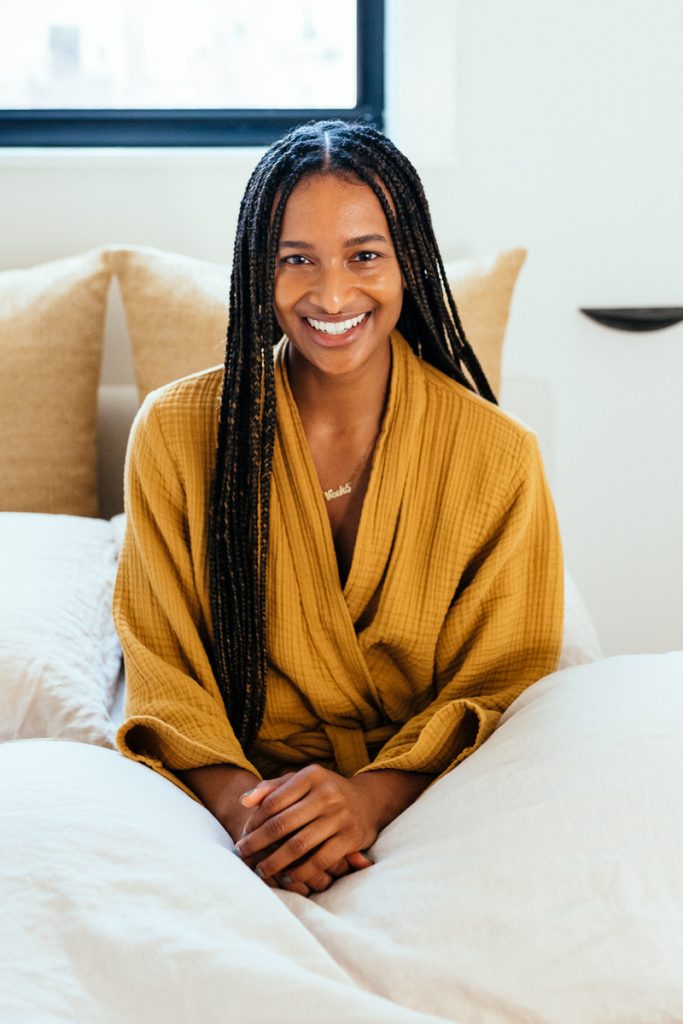 glowing happy woman in bed with robe