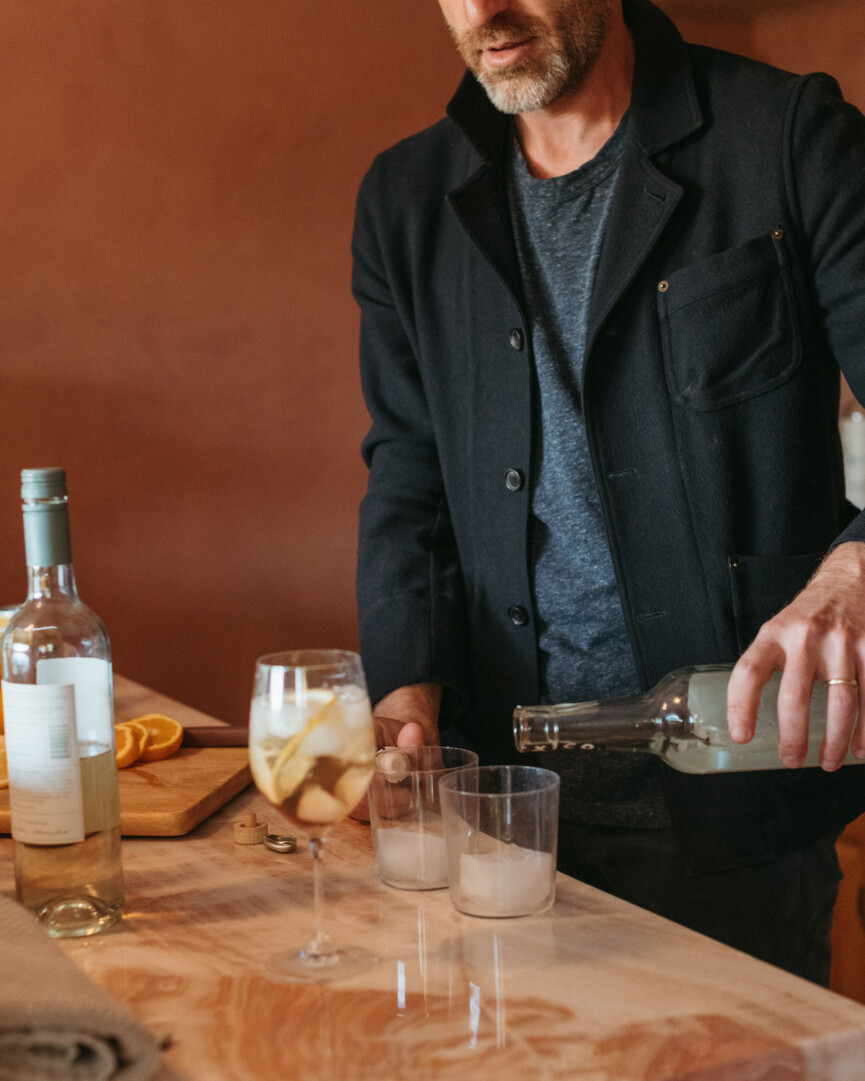 brian de lowe making cocktails at bar, colorful wall paint, white negroni