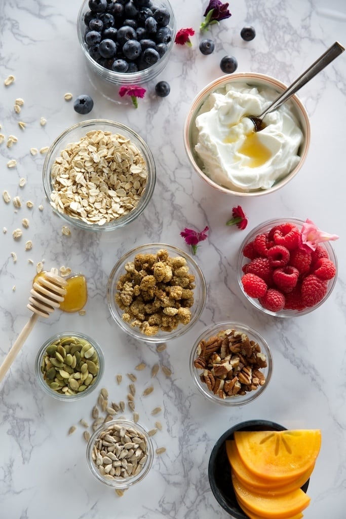 Honey Nut and Cinnamon Granola parfait bar with Greek yogurt, raspberries, and persimmon slices_when to drink coffee