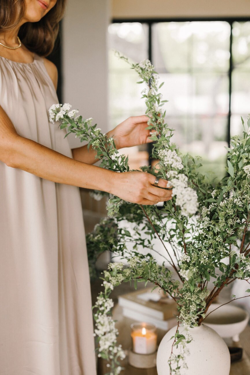 Woman arranging flowers.