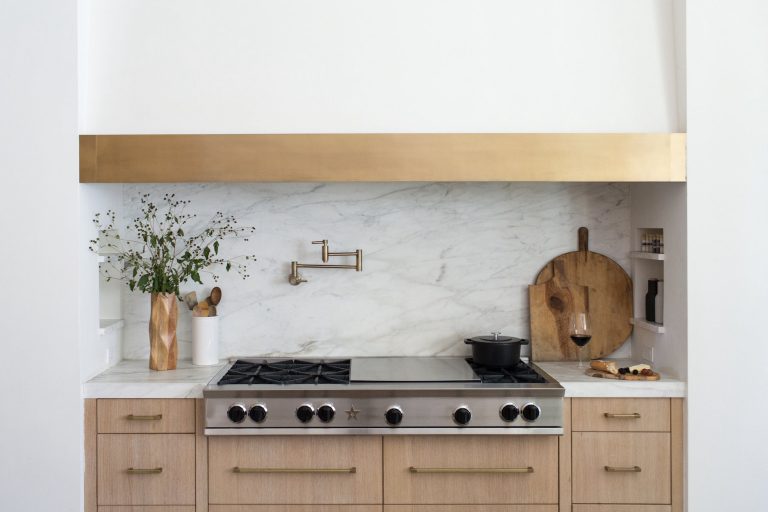simple range in white and marble kitchen