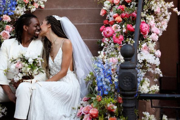 bride and groom amidst flowers