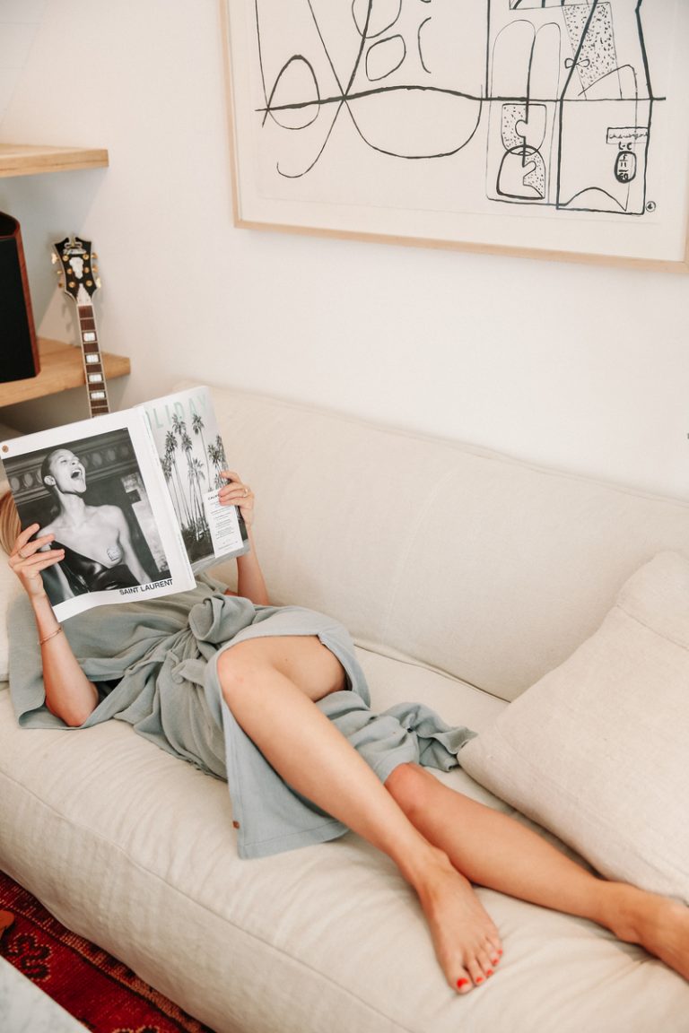 Emma Goodwin reads a magazine on the couch_best dating apps for your 30s