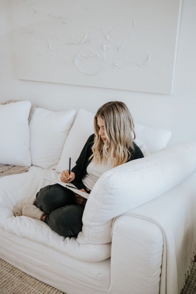Janessa Leoné journaling on couch_how to change