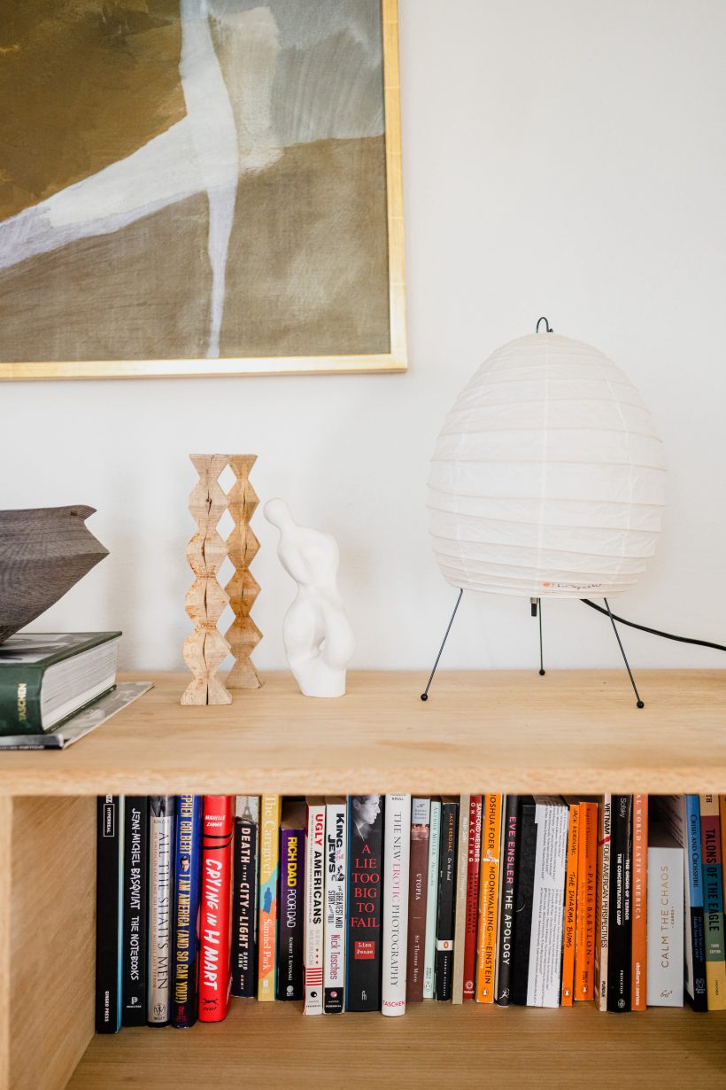white lamp on bookshelf