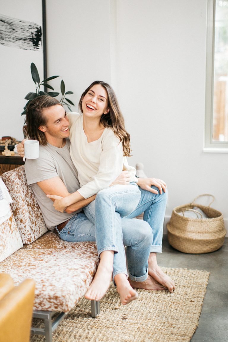 Kate Zimmerman Turpin and Luke Turpin sitting on the couch in their Austin home