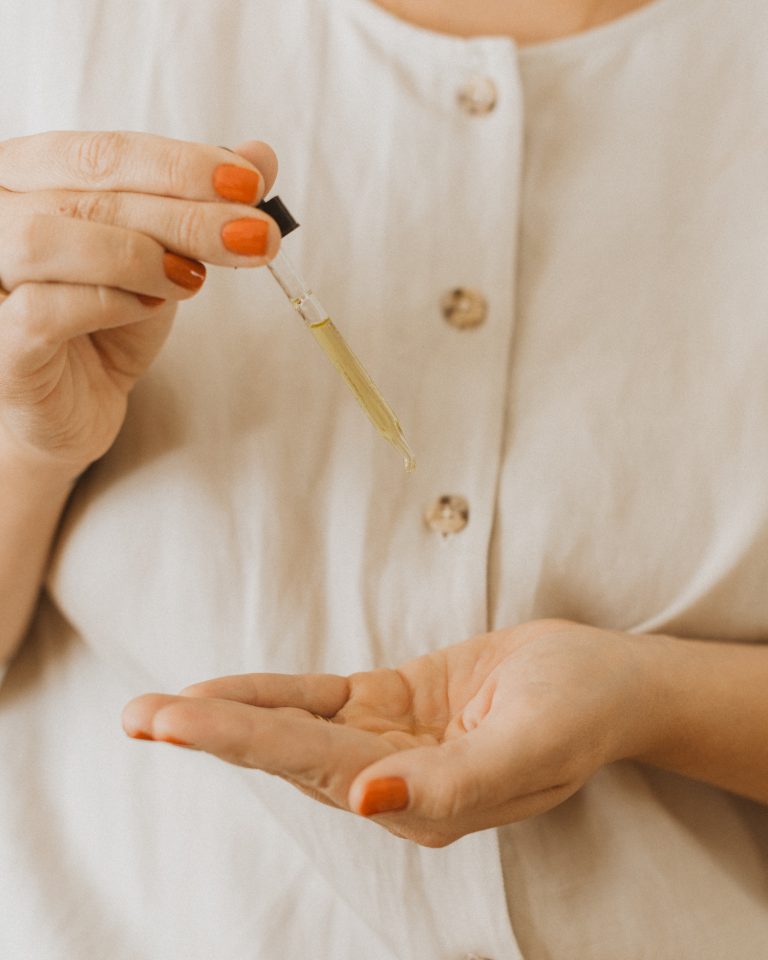 Woman using face oil, Trader Joe's Skincare