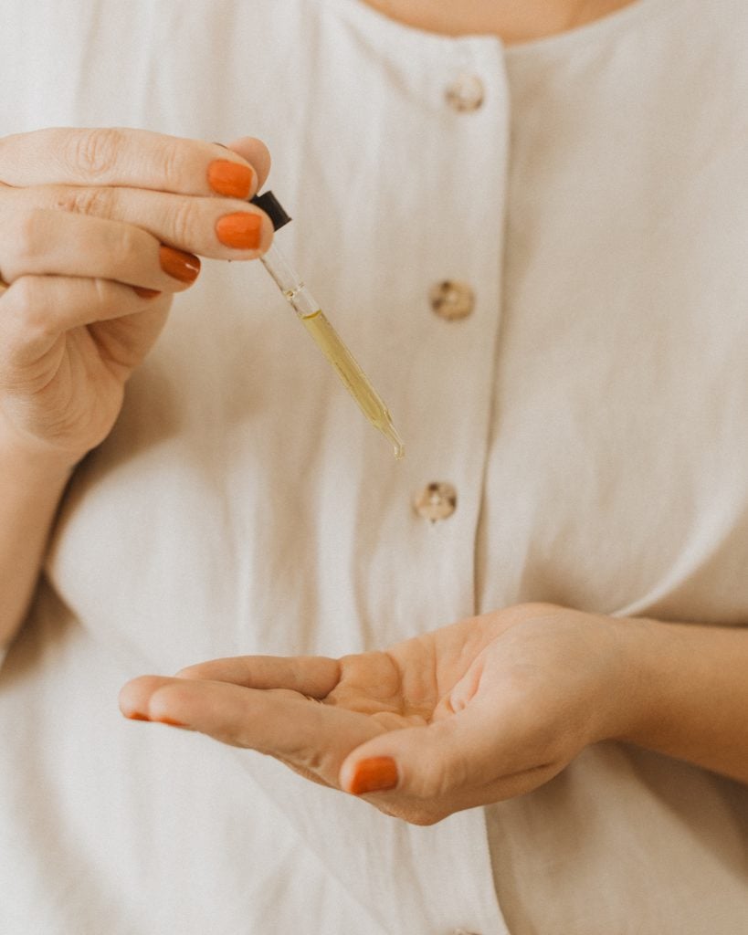 woman using face oil, trader joes skincare