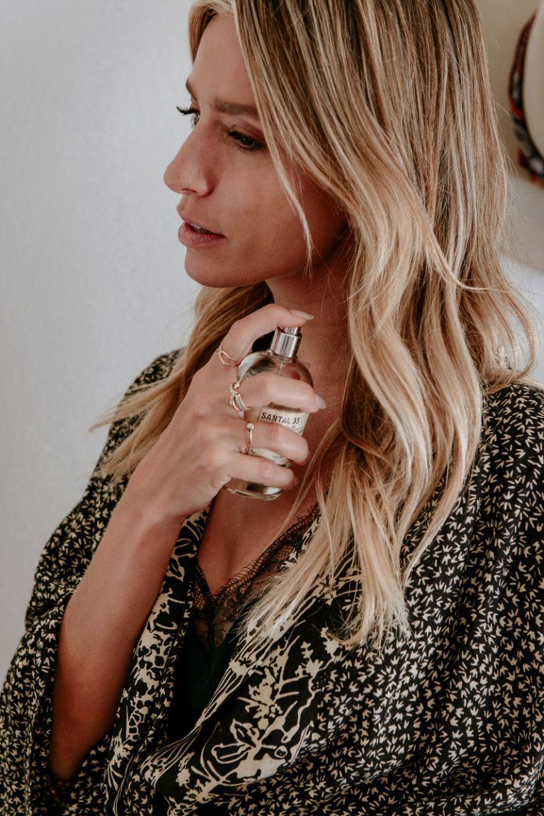 Woman spraying le labo perfume. 