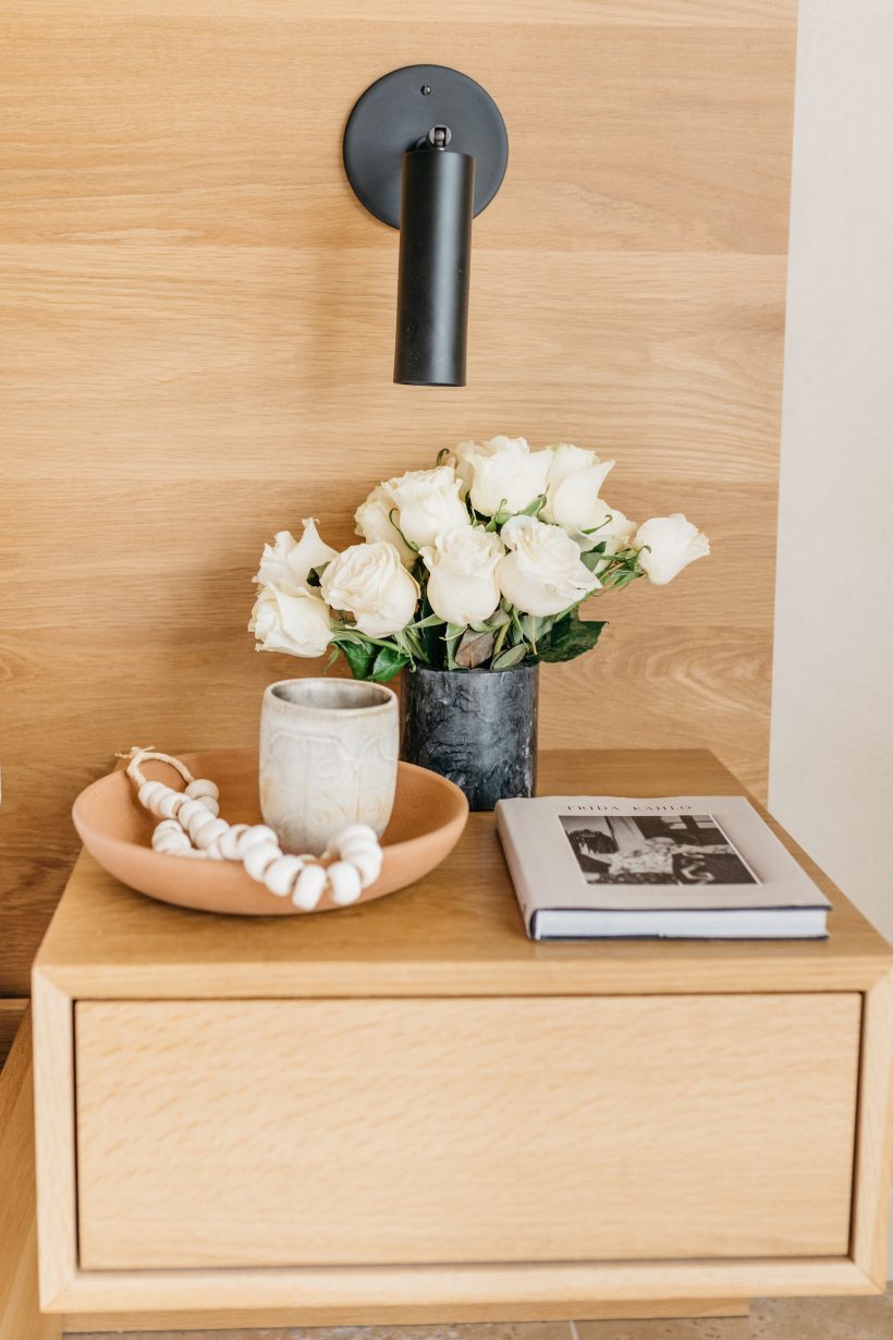 bedroom nightstand with candle and flowers