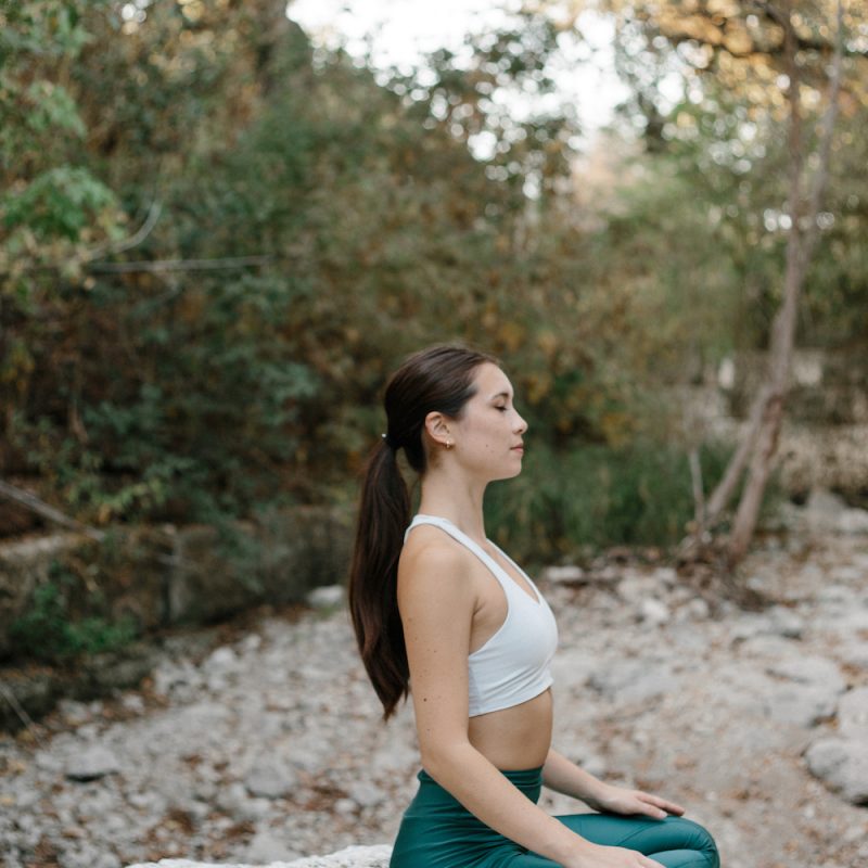 woman sitting on a rock in a seated position_birth control and vitamin deficiency